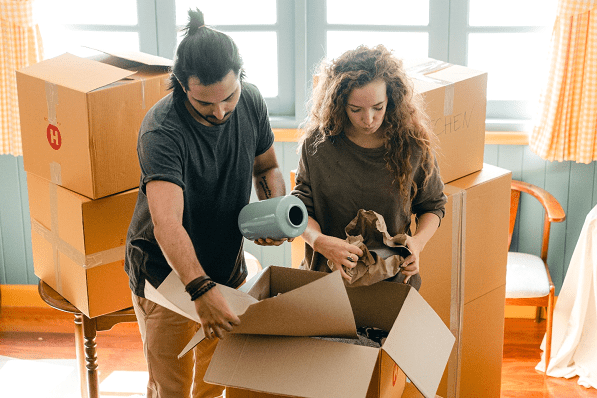 A man and women packing their house items for relocating to A new home
