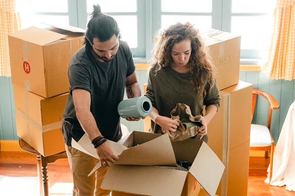 A man and women packing their house items for relocating to A new home